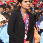 A teacher speaks to the assembly