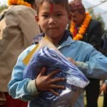 A boy with his new uniform pack
